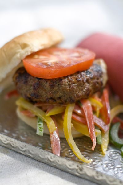 To bump up the heat in Chipotle Barbecue Cheeseburgers, add a jalapeno to the processor at the same time as the chipotles. (Associated Press)