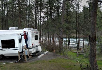 
Harvey Pearson cleans off his camper Monday during a stop at Bowl and Pitcher in Riverside State Park. Pearson and his wife are from  Montana. 
 (Brian Plonka / The Spokesman-Review)