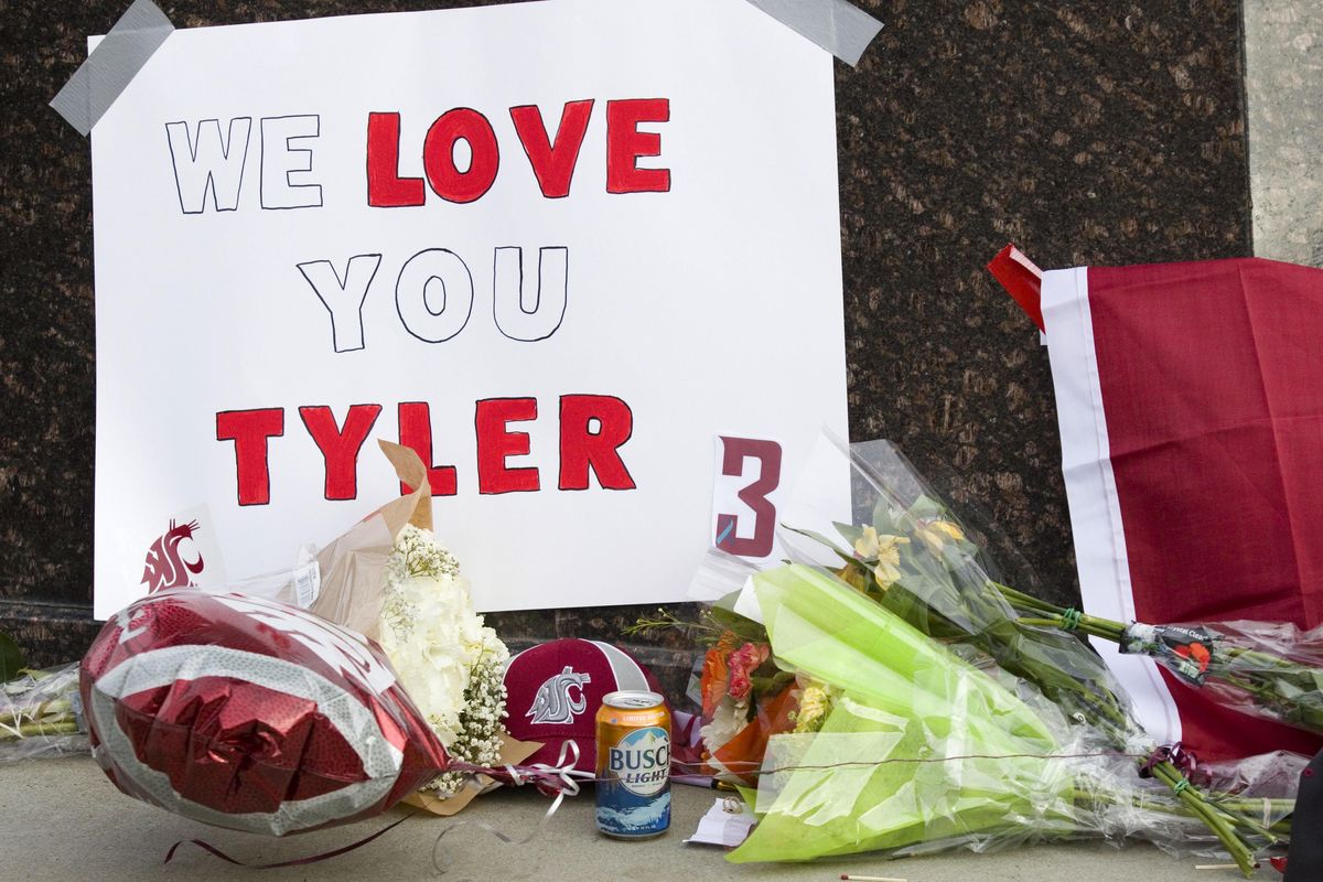 Items are left at a makeshift memorial for Washington State quarterback Tyler Hilinski outside Martin Stadium in Pullman, Wash., Wednesday, Jan. 17, 2018. (Geoff Crimmins / AP)