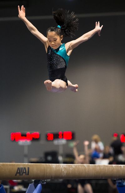 Bouncing beam: Sydney Kho of Winners Gymnastics performs her Junior 1 balance beam routine Friday during the first day of competition at the 2015 Junior Level 9 Western Championships being held through Sunday at the Spokane Convention Center. (Colin Mulvany)
