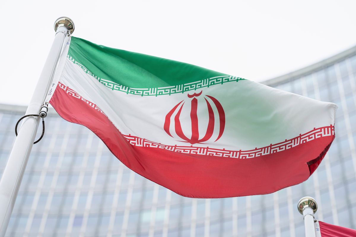 FILE - The flag of Iran waves in front of the the International Center building with the headquarters of the International Atomic Energy Agency, IAEA, in Vienna, AustriaI, May 24, 2021. On Monday, Nov. 29, 2021, negotiators are gathering in Vienna to resume efforts to revive Iran
