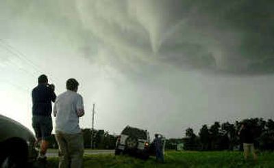 
Unidentified storm chasers watch a tornado form just south of Wichita, Kan., Saturday.
 (Associated Press / The Spokesman-Review)