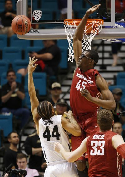 Washington State center Valentine Izundu blocks a shot by Colorado guard Josh Fortune (44) during the second half of an NCAA college basketball game in the first round of the Pac-12 tournament on March 9. (John Locher / Associated Press)