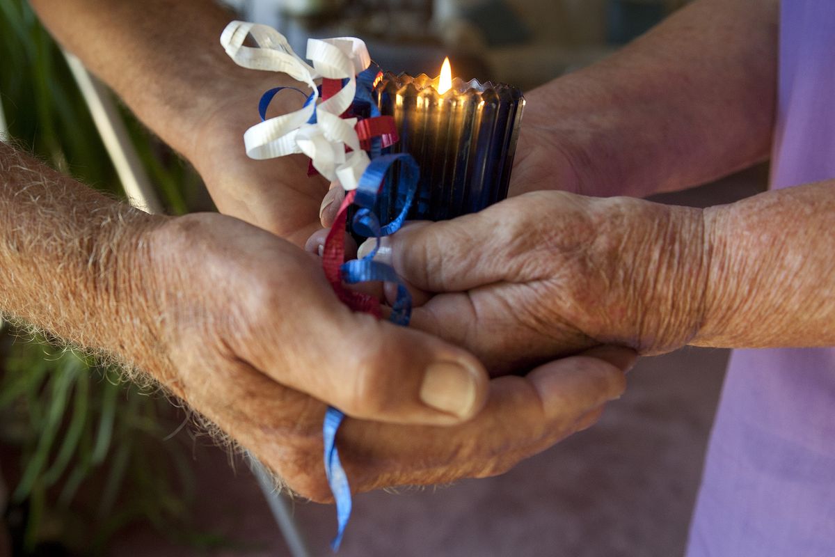 Every Sept. 11, Jack and Evans Anne Snizik light the memorial candle they found with an anonymous letter at a Lake Wenatchee campground almost 10 years ago. (Colin Mulvany)