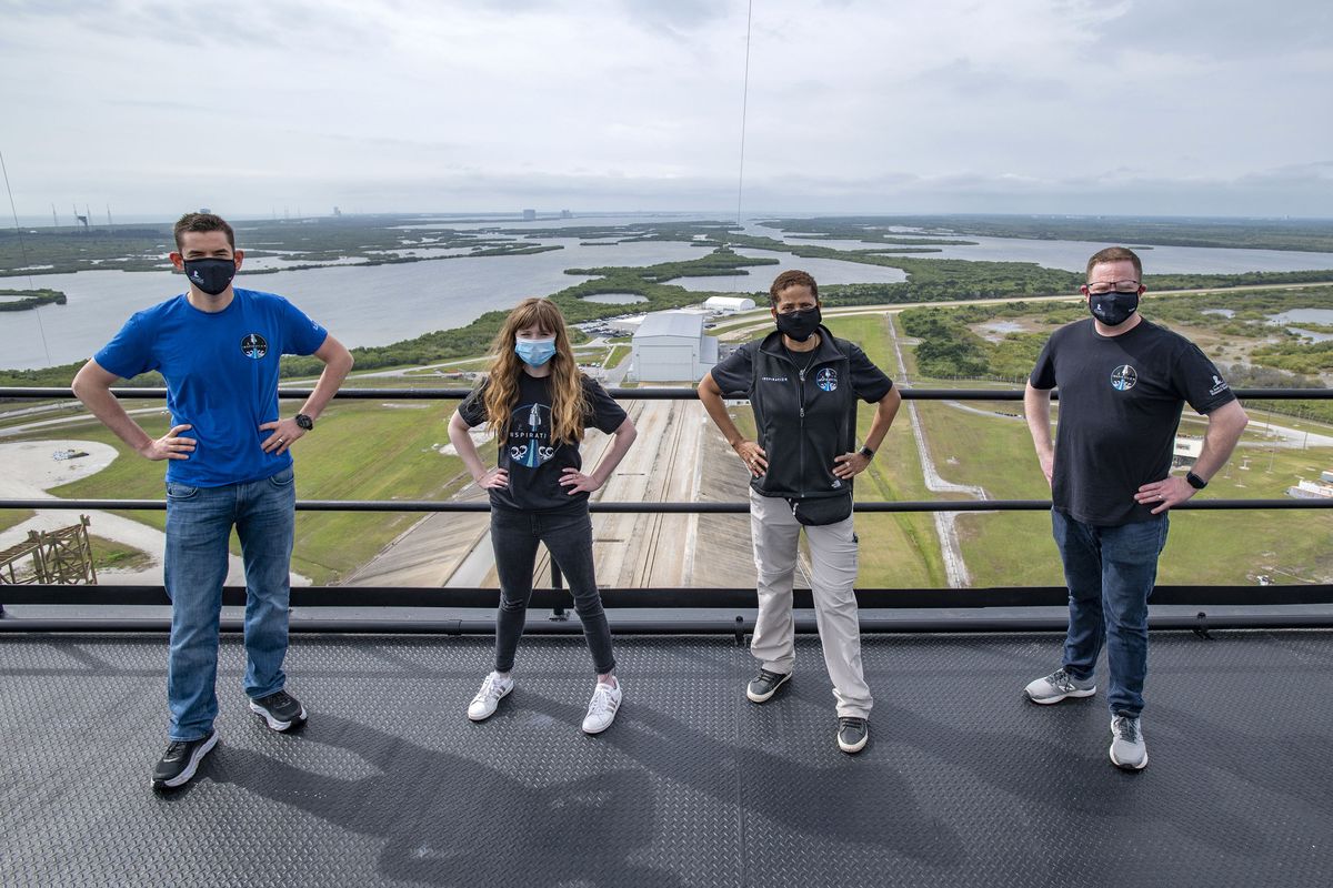 From left, Jared Isaacman, Hayley Arceneaux, Sian Proctor and Chris Sembroski pose for a photo Monday from the SpaceX launch tower at NASA’s Kennedy Space Center in Cape Canaveral, Fla.  (HONS)