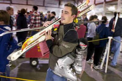 
Nick Snyder, of Rathdrum, Idaho, waits in line Friday to check in three pairs of skis and a pair of boots that he hopes to sell at the Mt. Spokane Ski Patrol's 40th annual Ski Swap today and Sunday at the Spokane Fair and Expo Center. 
 (Colin Mulvany / The Spokesman-Review)