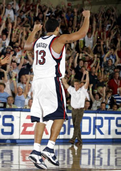 
Gonzaga's J.P. Batista and his coach in the background, Mark Few, give the victory salute as the Zags finish off their semifinal win over Michigan State. 
 (Associated Press / The Spokesman-Review)