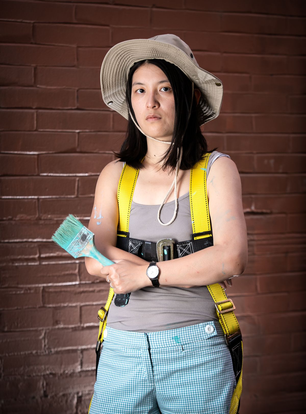 Artist Jiemei Lin pauses painting on her mural for a quick portrait in the same alley on July 16, 2020 in Spokane, Wash. Lin's mural was commissioned by Spokane Arts for the Alleyways Mural project and is located in the 100 N. block alley between Howard and Wall Streets.  (Libby Kamrowski/ THE SPOKESMAN-REVIEW)