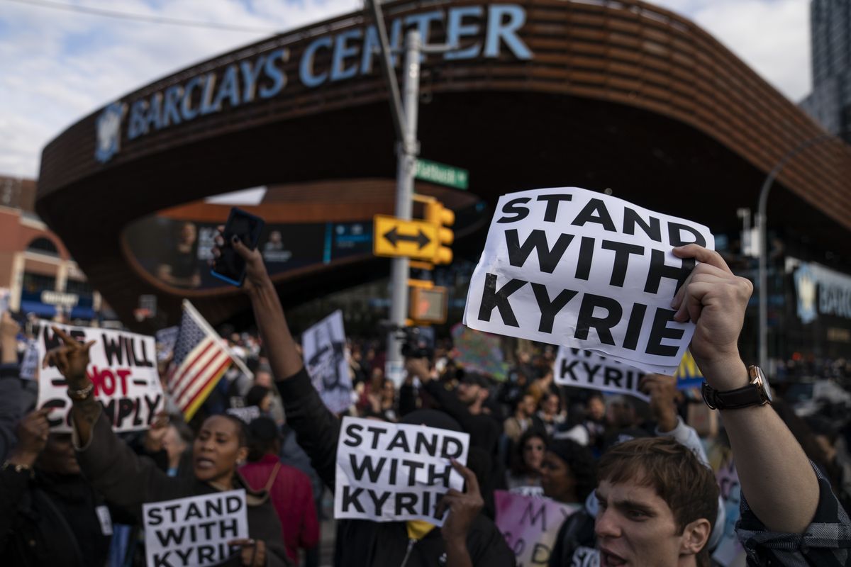 FILE - Protesters rallying against COVID-19 vaccination mandates and in support of basketball player Kyrie Irving gather in the street outside the Barclays Center before an NBA basketball game between the Brooklyn Nets and the Charlotte Hornets, Sunday, Oct. 24, 2021, in New York. From the NBA