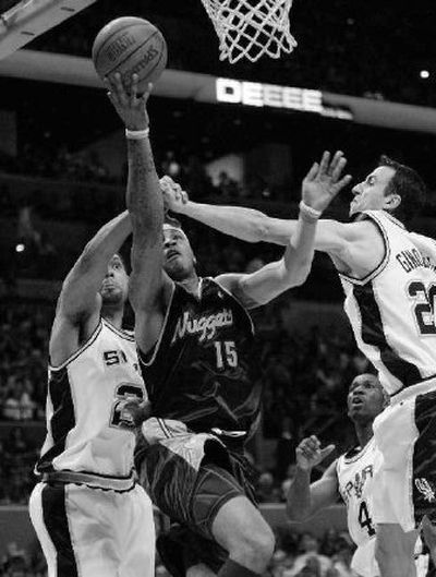 
Denver Nuggets forward Carmelo Anthony drives between San Antonio Spurs defenders. 
 (Associated Press / The Spokesman-Review)