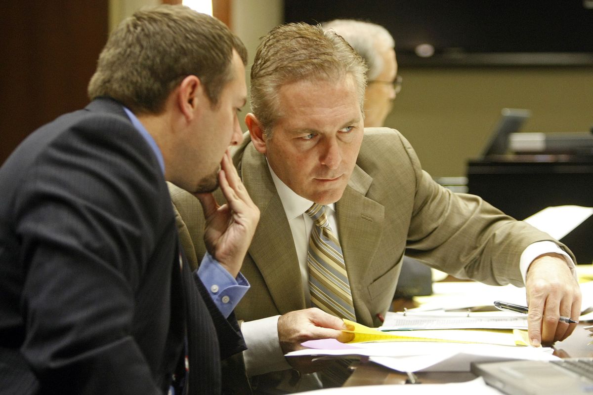 Defense attorney Andrew Cook whispers to Dr. Jon Norberg on Tuesday, Nov. 20, 2012, during Norberg