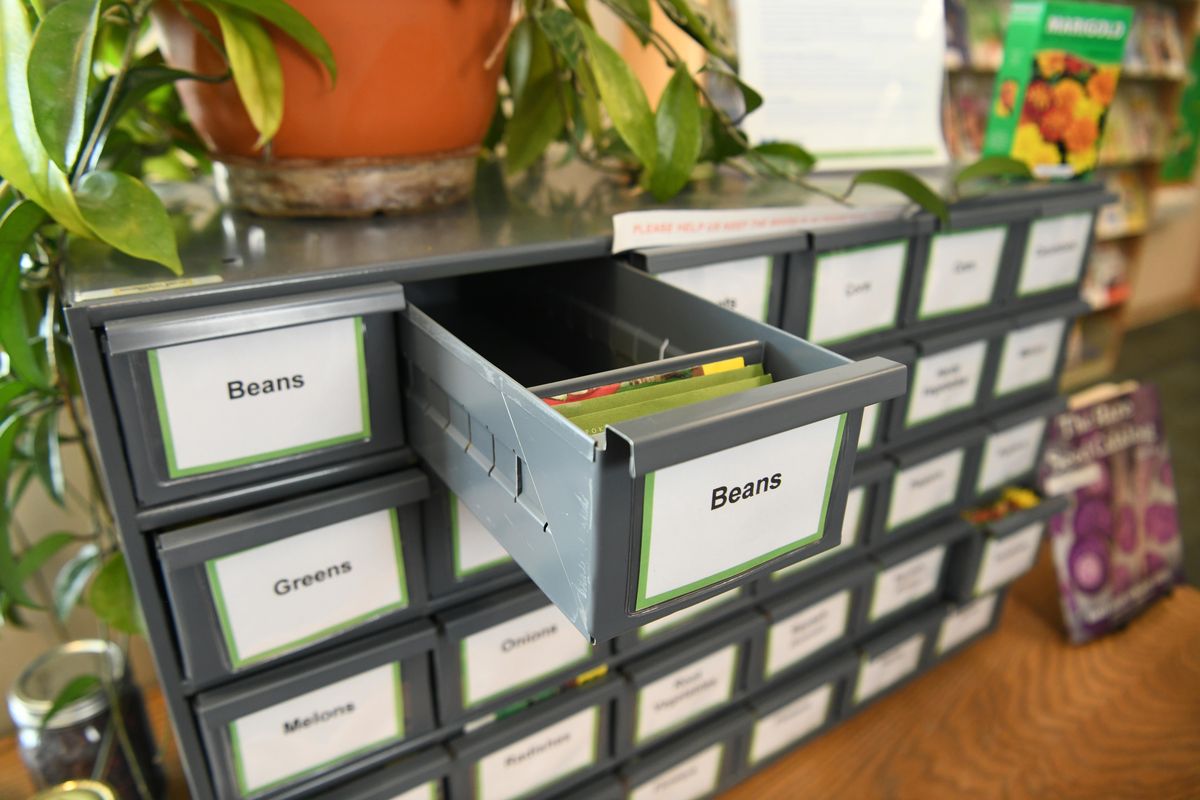 A simple card file holds the seeds available at the Otis Orchards County Library’s free seed bank Monday, March 11, 2019. Two other county libraries  have seed libraries that provide free seeds for gardeners and ask that they save some seeds to replenish the bank each year. (Jesse Tinsley / The Spokesman-Review)
