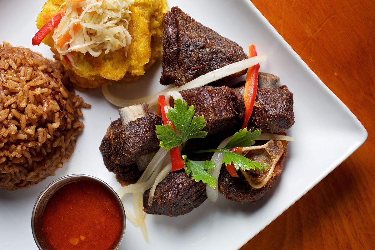 Fried chile-marinated goat (taso kabrit), rice, bannann peze (fried plantains) and pikliz (pickled slaw) at Port-au-Prince Haitian Cuisine in Silver Spring in 2018.  (Deb Lindsey/For the Washington Post)