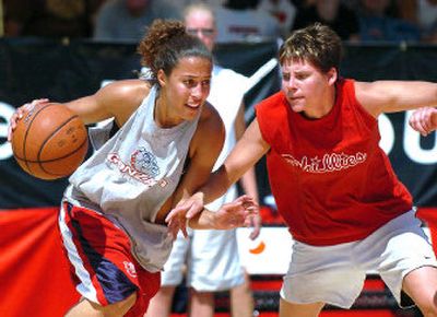 
MVP of the women's division Shannon Matthews drives past Phillies' Lindsay Herbert in the finals Sunday at center court. 
 (Joe Barrentine / The Spokesman-Review)