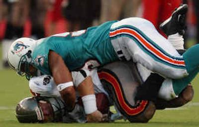 
Dolphins defensive end Jason Taylor, top, leads a Miami defense that ranks first in the NFL against the pass and next-to-last against the run.
 (Associated Press / The Spokesman-Review)