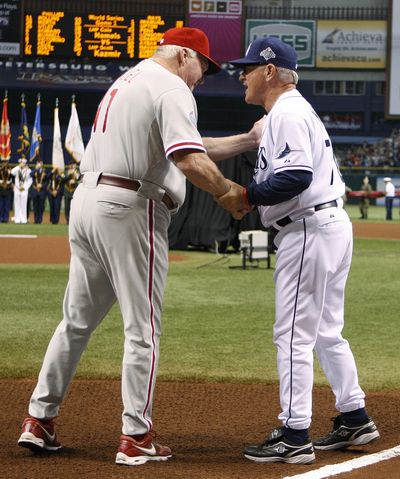Phillies manager Charlie Manuel, left, and the Rays’ Joe Maddon will have some big decisions to make when play finally resumes.  (Associated Press / The Spokesman-Review)