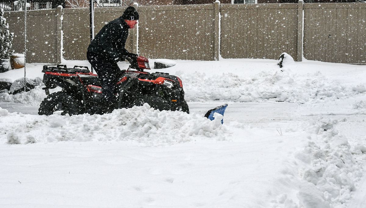Wade Dissmore jumped on his ATV to plow his driveway and street during the heavy snowstorm Monday in Spokane. A bigger storm is expected to move into the Spokane area Wednesday night into Thursday, dropping 4 to 7 inches of snow in the Spokane-Coeur d’Alene area.  (DAN PELLE/THE SPOKESMAN-REVIEW)
