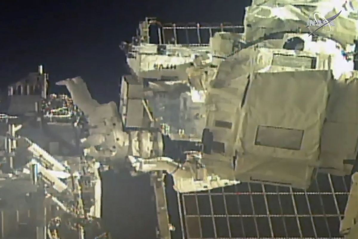 In this image taken from NASA video, commander Chris Cassidy, right, and NASA astronaut Bob Behnken perform their second spacewalk in under a week Wednesday, July 1, 2020, to replace old batteries outside the International Space Station.  (HOGP)