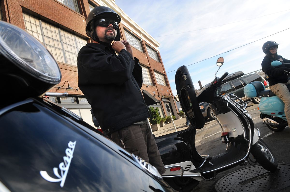 Scott Leinen gears up for a ride on his Vespa. (Rajah Bose / The Spokesman-Review)