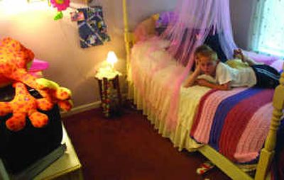 
Chase Day, 8, and his sister, Allie, 4, watch television in Allie's room in Myrtle Beach, S.C. Most of the items in the room came from a dollar store.
 (Knight Ridder / The Spokesman-Review)