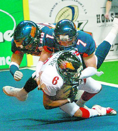 Spokane's Jermaine Harris and Rob Keefe (7) stop Aleric Clark on a kick return. (Amanda Smith / The Spokesman-Review)