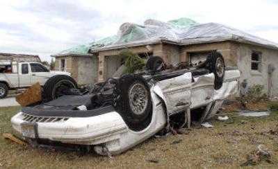 
An automobile rests on its roof after a tornado struck a community in The Villages, Fla., on Friday. At least 19 people were killed and hundreds of buildings were damaged or destroyed in a day of storms. 
 (Associated Press / The Spokesman-Review)