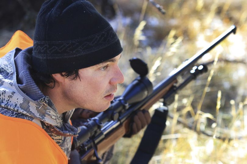 In this November 2016 photo, Livingston hunting guide Justin Souza appears near the scene where he shot and killed a charging grizzly bear in the mountains near Emigrant, Montana's Glastonbury neighborhood as investigators gather evidence. Souza encountered the bear while he was elk hunting in the area the morning before and said he shot the grizzly in self-defense. The grizzly bear is classified as a threatened species. (Hunter D'Antuono / Livingston Enterprise via AP)