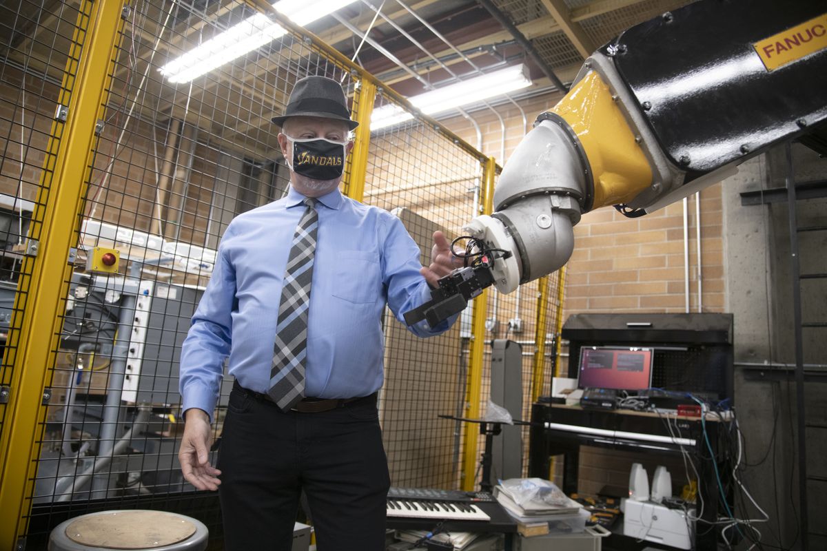 Professor John Shovic talks about the potential uses of the giant articulated arm robot in the University of Idaho robotics lab at North Idaho College in Coeur d’Alene, the new location of the program that his been in Coeur d’Alene for three years. The robot was donated by Boeing. The Coeur d’Alene-based program offers advanced degrees in robotics.  (Jesse Tinsley/THE SPOKESMAN-REVI)