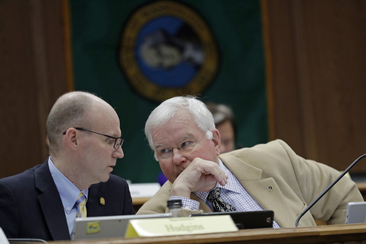 Sen. Sam Hunt, right, D-Olympia, the chairman of the State Government, Tribal Relations and Elections Committee, confers with Rep. Zack Hudgins, left, D-Tukwila, chairman of the State Government, Elections & Information Technology Committee, during a joint work session, Thursday, Feb. 22, 2018, at the Capitol in Olympia, Wash. The session was held to discuss a bill filed Wednesday by lawmakers who want to circumvent a recent court ruling finding them fully subject to the state's public disclosure laws. The bill would make some of their records public but would retroactively prohibit the release of other records being sought by a coalition of news organizations. (Ted S. Warren / AP)