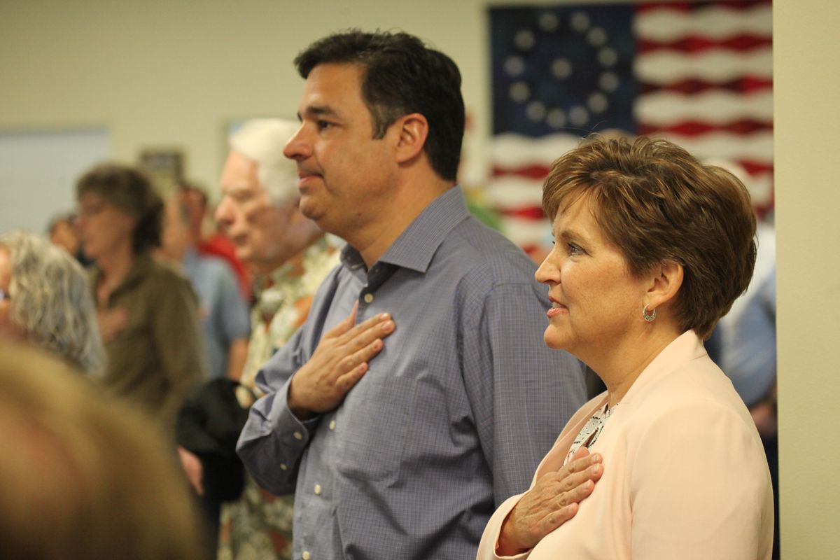 Congressman Raul Labrador and his wife, Becca, pledge allegiance to the flag prior to his announcement in Post Falls Wednesday that he