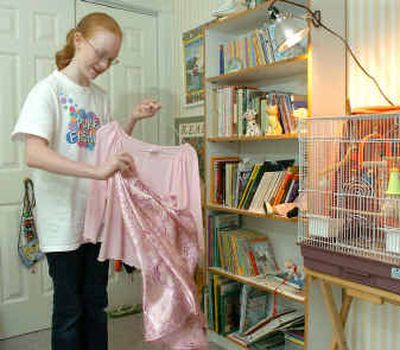 
Ella Gunderson, 11, pulls an outfit from her bedroom closet in Redmond, Wash.Ella Gunderson, 11, pulls an outfit from her bedroom closet in Redmond, Wash.
 (Associated PressAssociated Press / The Spokesman-Review)