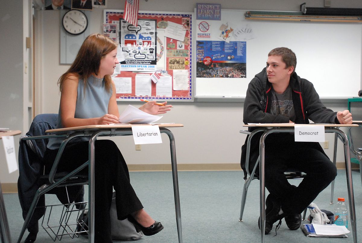 The Spokesman-Review Ayla Paulson, left, and Taylor Feldmuth, representing Libertarian and Democratic candidates, debate Wednesday at EVHS. History classes at EV are holding debates and votes as they learn about the political system. (Jesse Tinsley / The Spokesman-Review)