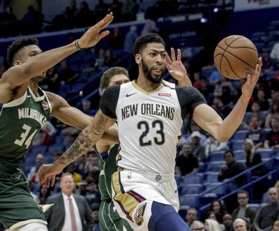 In this Tuesday, March 12, 2019 photo, New Orleans Pelicans forward Anthony Davis (23) takes an outlet pass against Milwaukee Bucks forward Giannis Antetokounmpo (34) in the first half of an NBA basketball game in New Orleans. Pelicans basketball operations chief David Griffin says the timing of next week’s NBA draft won’t necessarily raise urgency to trade disgruntled six-time All-Star Anthony Davis. The Pelicans have the first overall pick in the June 20 NBA draft and likely could acquire more high picks by dealing Davis by then. (Scott Threlkeld / Associated Press)