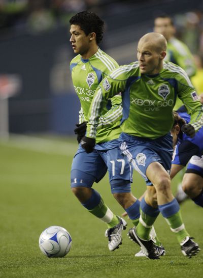 Seattle Sounders FC forward Fredy Montero, left, looks to pass.  (Associated Press / The Spokesman-Review)