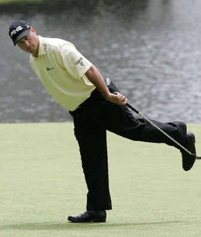 
Leader Chris DiMarco coaxes in a birdie putt on the 16th hole during Saturday's second-round play of the 2005 Masters at  Augusta National. 
 (Associated Press / The Spokesman-Review)