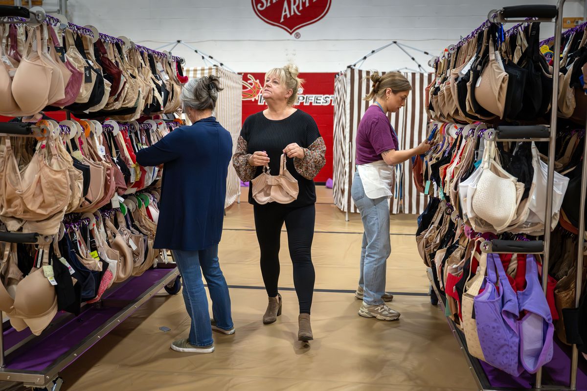 Bra fitter Renee Norris, left, Breast Intentions board member Robin Benton, and bra fitter and board member Maddie Weiler search for bras to fit clients during a Breast Intentions event held Oct. 10 at the Salvation Army. The organization has helped thousands of women in need gain confidence and dignity with free quality bras that fit.  (COLIN MULVANY/The Spokesman-Review)