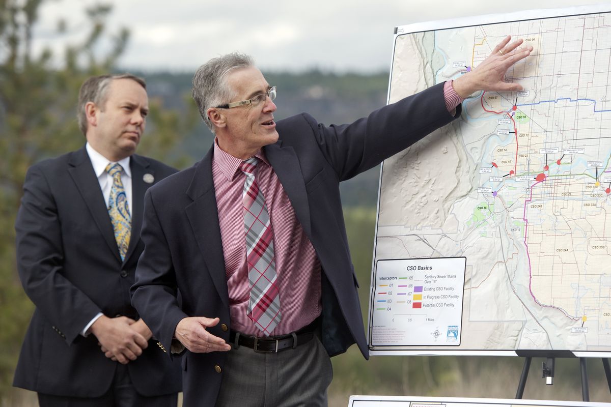 Spokane Mayor David Condon, left, watches Rick Romero of the city Utilities Department talk Monday about future stormwater projects like the one on Northwest Boulevard. The city will start a series of major projects as weather permits. (Jesse Tinsley)