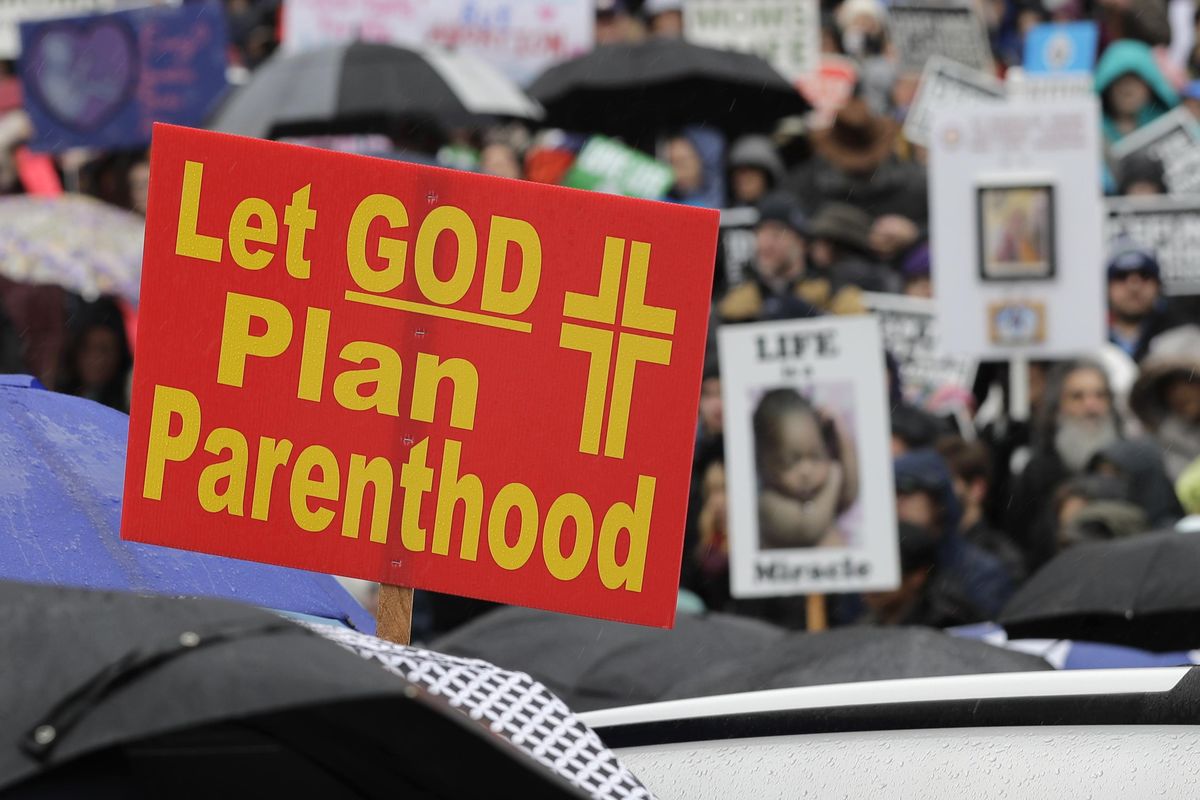 A sign reads “Let GOD Plan Parenthood,” during an anti-abortion march and rally, Tuesday, Jan. 22, 2019, at the Capitol in Olympia, Wash. The event was part of annual “March for Life” events held in other states and Washington, D.C., near the Jan. 22, 1973 anniversary of the Supreme Court’s Roe v. Wade decision, which legalized abortion. (Ted S. Warren / Associated Press)