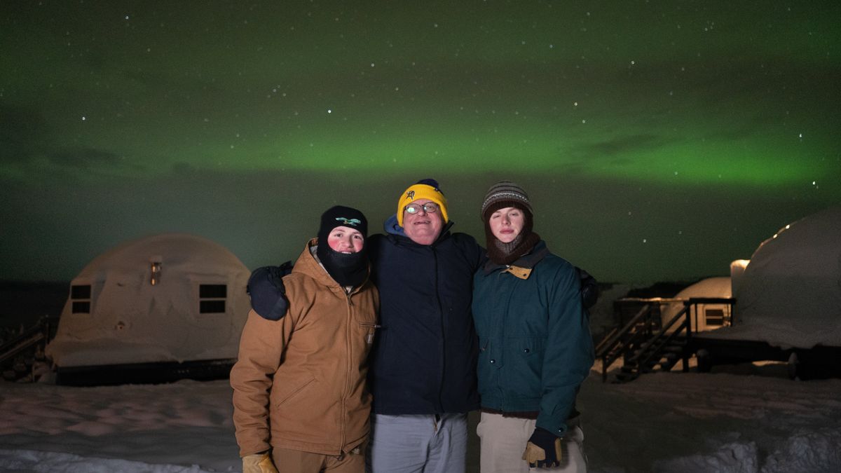 Milo, Ed and Eddie Condran pose in front of Borealis Base Camp, 25 miles from the urban illumination of Fairbanks on a property with 100 acres of forest.  (Ed Condran/The Spokesman-Review)