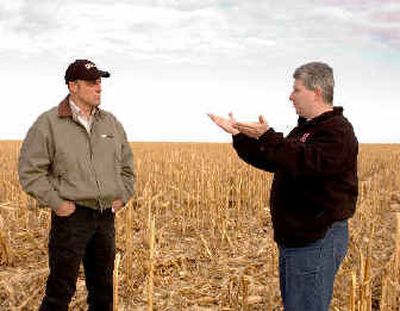 
Landowner Fredrick Gillis, right, talks to Paul Schadegg from Farmers National Company, as they stand Jan. 31, 2005, on a cornfield that Schadegg farms for Gillis, near Imperial, Neb. 
 (Associated Press / The Spokesman-Review)