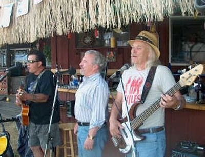 
Members of The Tiger Mike Show perform following a Harley-Davidson poker run. Group members include, from left, Tiger Mike, Mike McFarland and James Adams.
 (Herb Huseland / The Spokesman-Review)