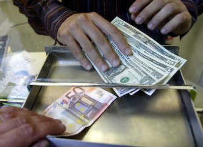 
An employee changes euro and U.S. dollars  at an exchange kiosk in downtown Milan, Italy, in this July 5, 2005, photo. Associated Press
 (File Associated Press / The Spokesman-Review)