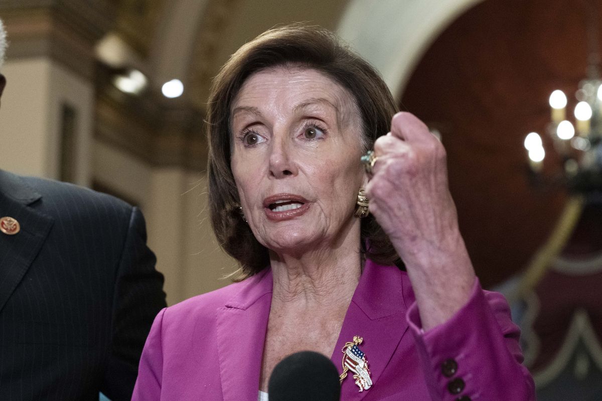 Speaker of the House Nancy Pelosi, D-Calif., talks to reporters at the Capitol in Washington on Friday after a day of delays in the vote to advance President Joe Biden’s domestic policy package.  (Jose Luis Magana)