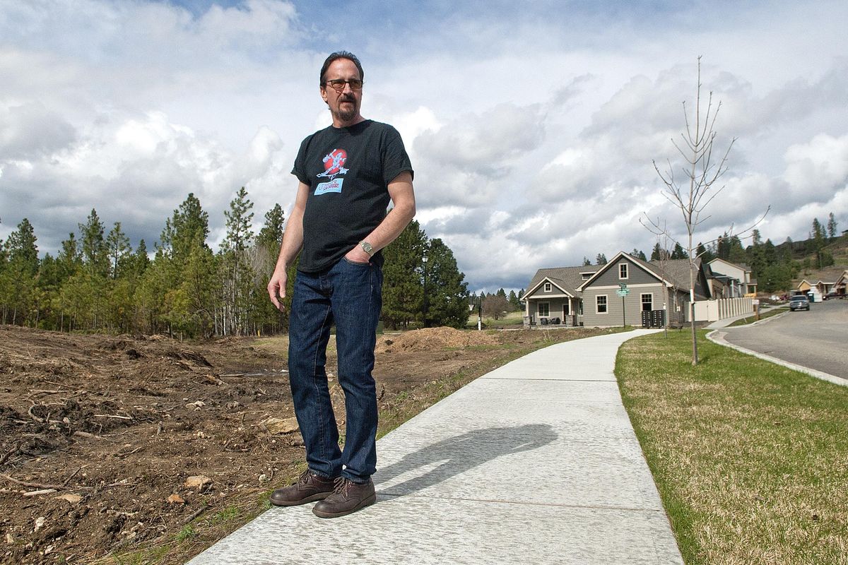 Spokane Valley resident Ben Smith stands near the Timberlane Terrace development situated on a hill above his home on Thursday, April 13, 2017. He says that the existing properties down hill from the development have been experiencing problems such as flooding and lost value. Kathy Plonka/THE SPOKESMAN-REVIEW (Kathy Plonka / The Spokesman-Review)