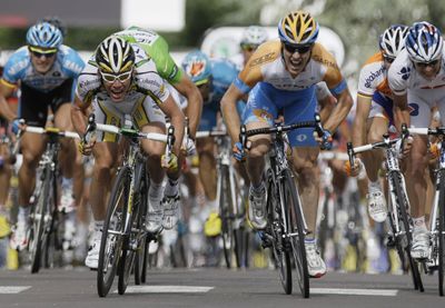 Mark Cavendish of Britain, left, races Wenatchee’s Tyler Farrar, center, in the last meters of Wednesday’s stage. (Associated Press / The Spokesman-Review)