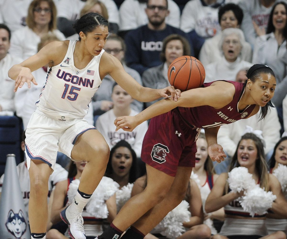 UConn’s Gabby Williams, left, and South Carolina’s Allisha Gray chase a rebound in the first half on Monday. (Jessica Hill / Associated Press)