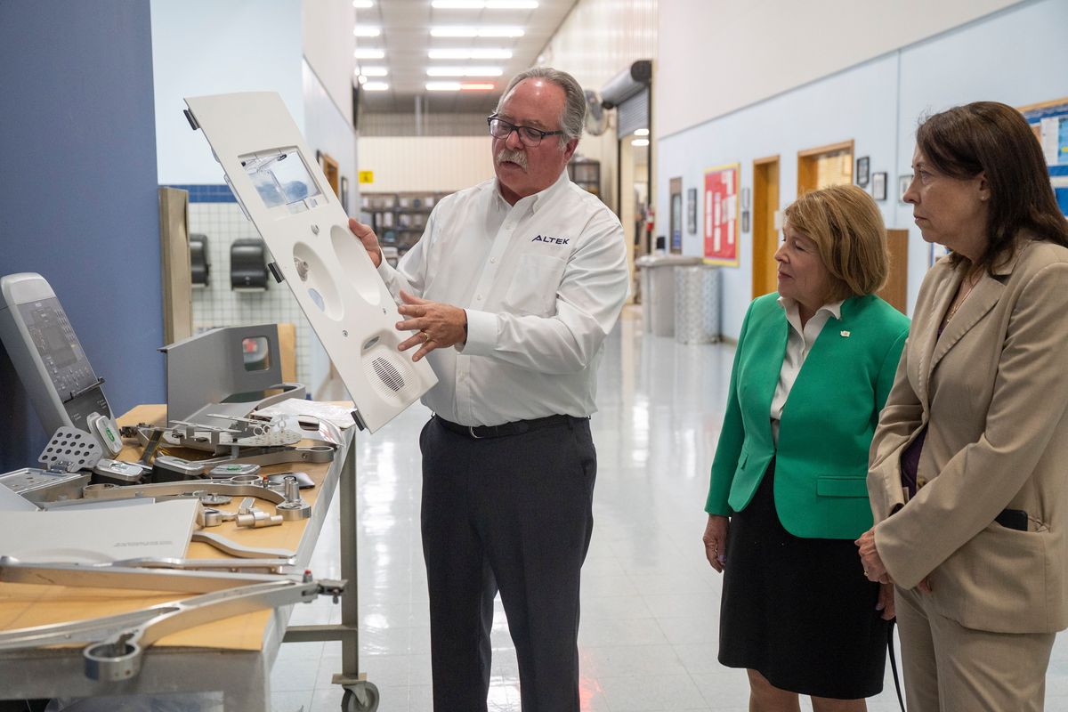 Rick Taylor, vice president of Altek in Liberty Lake, shows airplane interior parts that are made at Altek on a tour of his plant for Director of the state Department of Commerce Director Lisa Brown, center, and U.S. Sen. Maria Cantwell, after Cantwell touted the CHIPS and Science Act recently passed by the U.S. Congress.  (Jesse Tinsley/The Spokesman-Review)