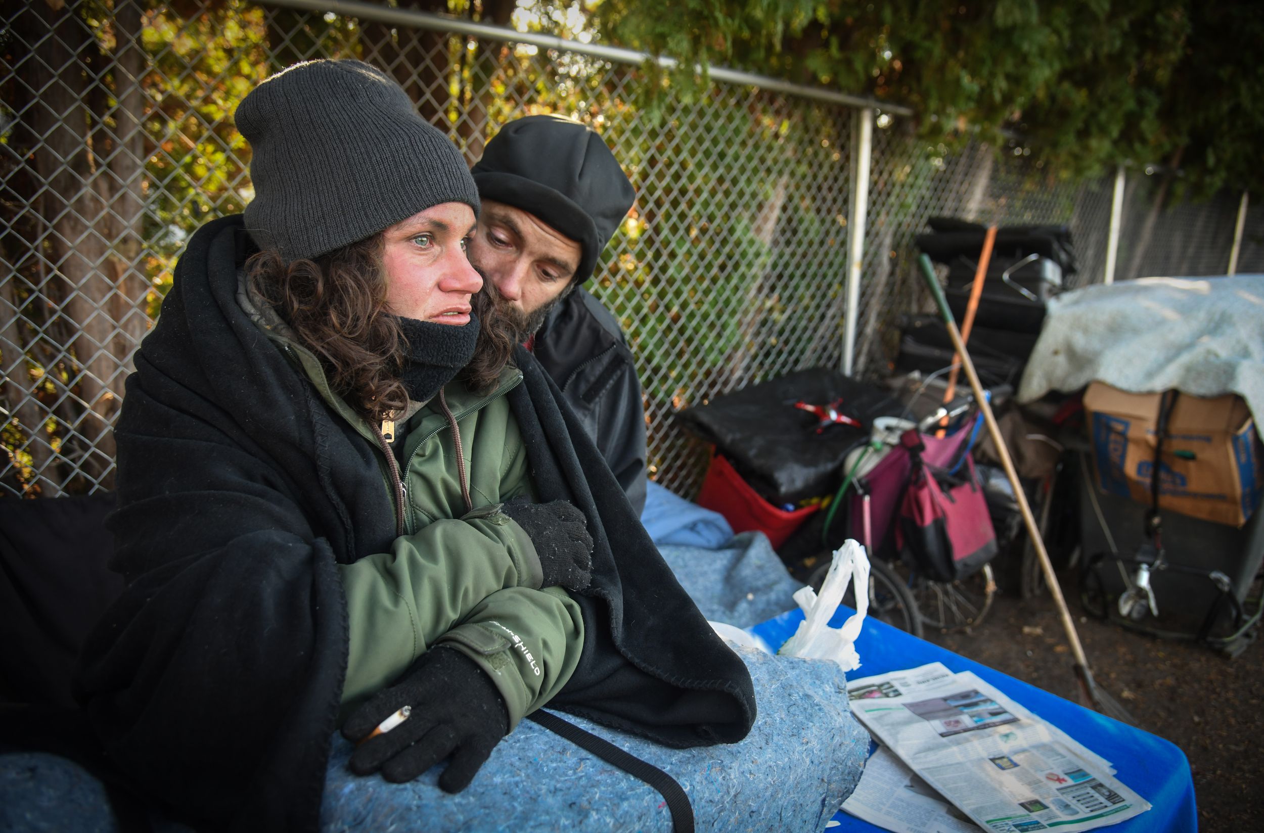 Angela Dallman and Nic Mischke, along with their possessions, spend the afternoon of Nov. 1, 2019, at Balfour Park in Spokane Valley. (DAN PELLE/THE SPOKESMAN-REVIEW)