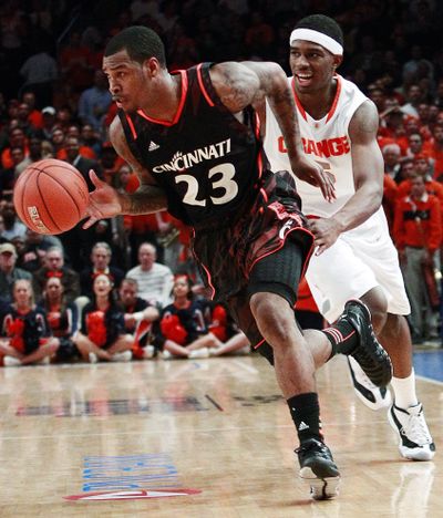 Cincinnati’s Sean Kilpatrick drives past Syracuse’s C.J. Fair on his way to scoring 18 points in Bearcats’ upset win on Friday. (Associated Press)