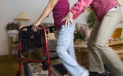 
Physical therapist Jenyne West  helps Rebecca Caballero with exercises to strengthen her hip  on Dec. 11. Thanks to a cousin, the medical community and the Filipino American Association of the Inland Empire, Caballero of Cebu Island, Phillipines, received a right-hip replacement on Nov. 29 and is making strides every day. 
 (CHRISTOPHER ANDERSON / The Spokesman-Review)
